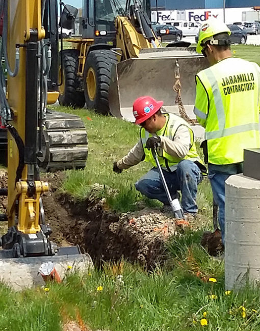 Men excavating for fiber optic cable