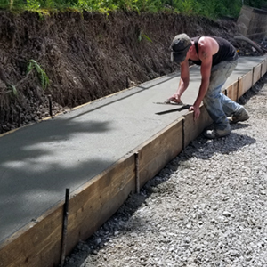 Concrete contractor putting finishing concrete sidewalk