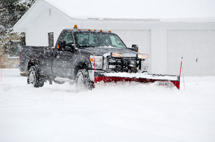 Pickup truck plowing snow